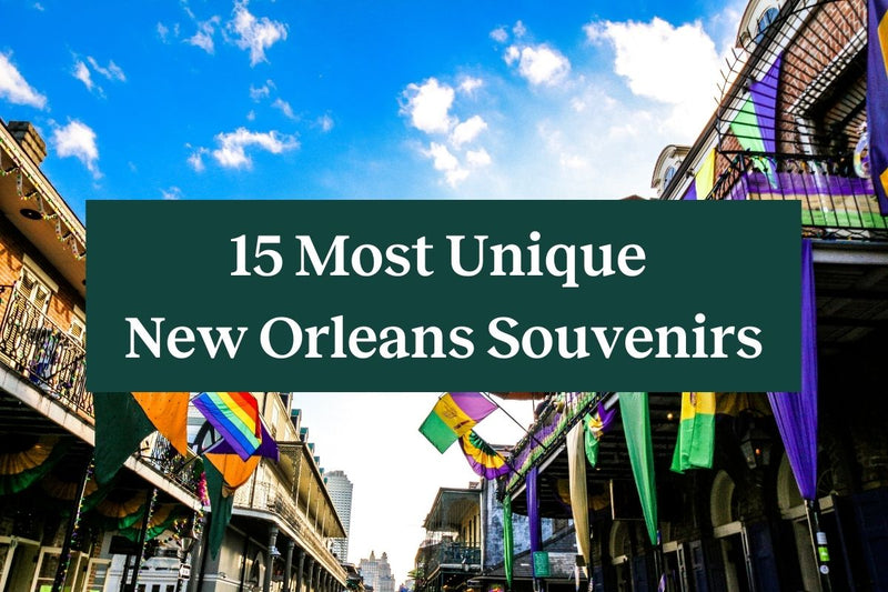 Buildings lining Bourbon Street with colorful flags hanging from them and a green rectangle with white letters that says