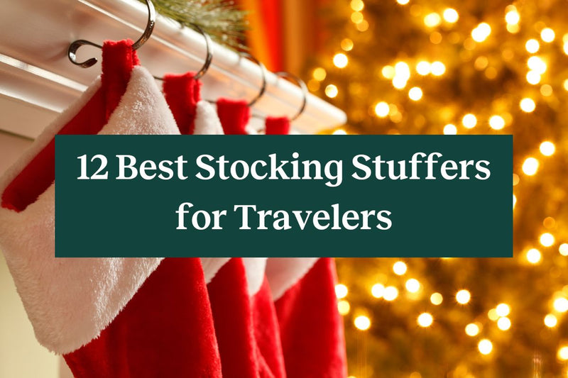 Four red and white stockings hung from a mantle with twinkling lights and a green rectangle with the words