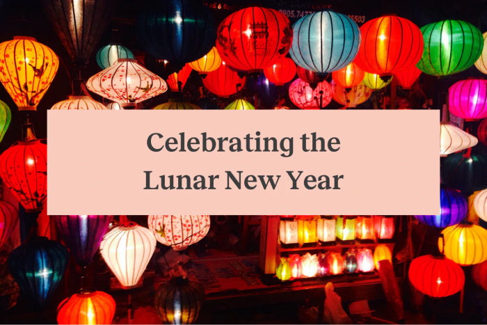 Several colorful paper lanterns hanging and a pink rectangle with the words "Celebrating the Chinese Lunar New Year"