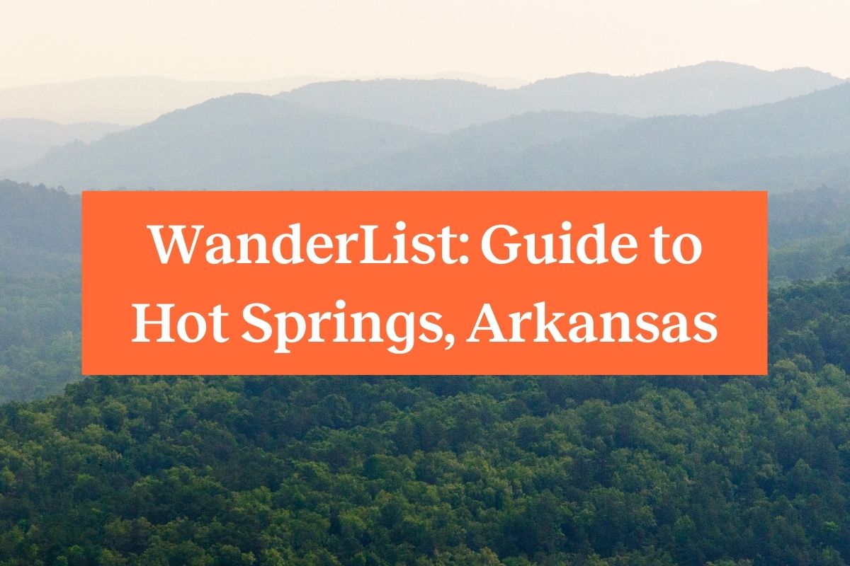 Rolling hills in the Ouachita Mountains on a hazy day and an orange rectangle with the words "WanderList: Guide to Hot Springs Arkansas" 