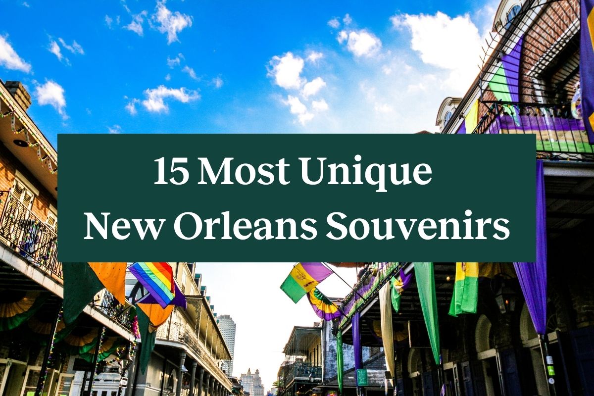 Buildings lining Bourbon Street with colorful flags hanging from them and a green rectangle with white letters that says "15 Most Unique New Orleans Souvenirs"